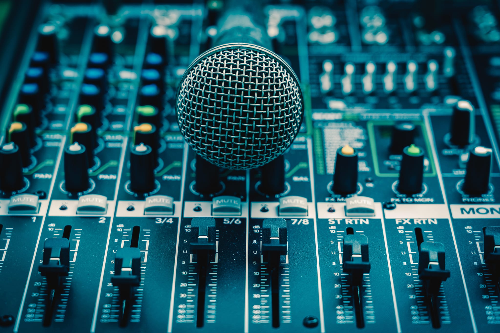 Closeup microphone over the audio mixer, vintage film style, music equipment concept