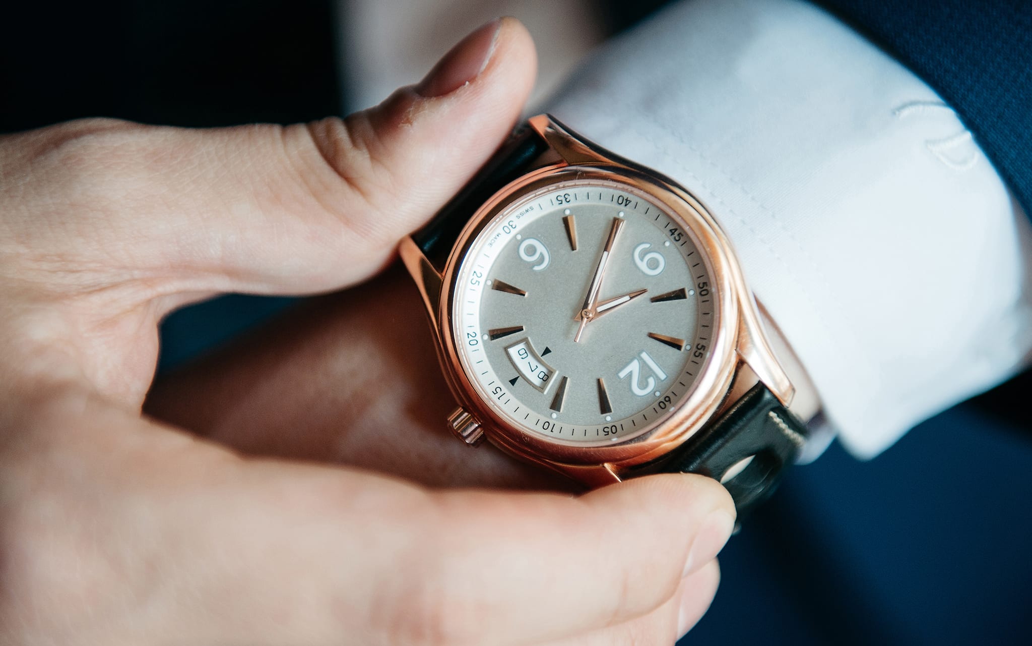 businessman looking at his watch on his hand, watching the time
